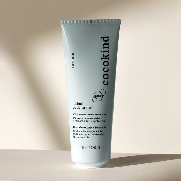 The Cocokind Retinol Body Cream with squalane, shown against a neutral background, features a label emphasizing ceramide and retinol for smoother skin texture. This 8 fl oz (236 ml) moisturizer delivers enhanced hydration and rejuvenation.