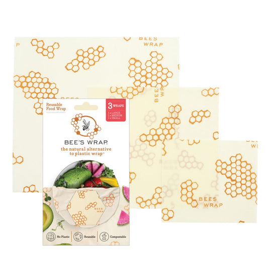 Three sheets of Bee's Wrap Reusable Beeswax Food Wraps – Assorted 3 Pack, featuring a honeycomb and bee pattern, are displayed beside their packaging as a sustainable, plastic wrap alternative.