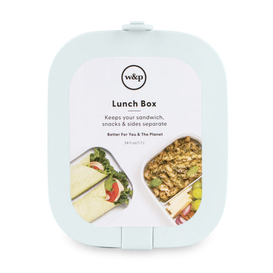 The mint green Reusable Bento Box by W&P features labeled compartments for a wrap with salad and another for pasta and grapes. It keeps your sandwich, snacks, and sides separate. This portable design has a 34 fl oz / 1 L capacity.