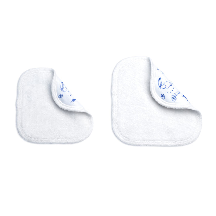 Two Mustela Reusable Eco-Wipes are displayed, each with a corner folded to reveal a blue animal print. Made from organic cotton, these white washcloths feature rounded corners and are perfect for family-friendly cleanups, elegantly set against a plain white background.