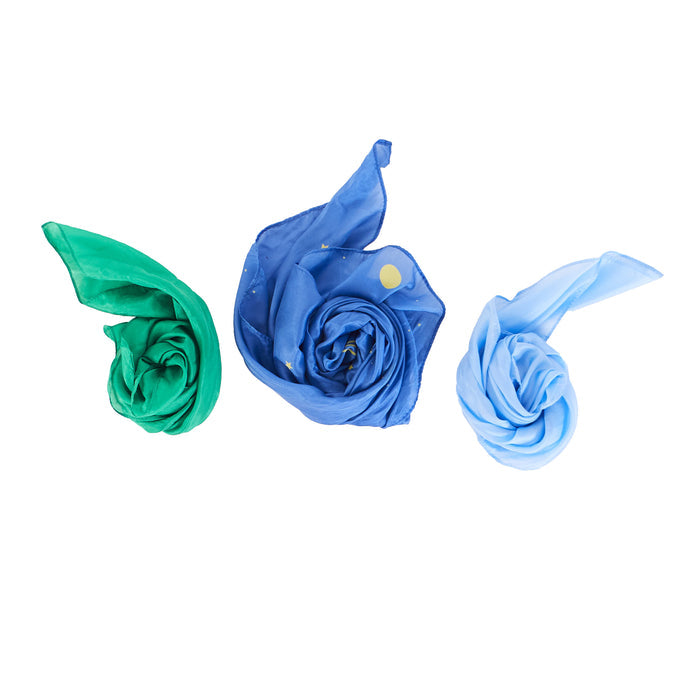 The Reusable Gift Wrap Furoshiki Set from Sarahs Silks includes three mulberry silk scarves, spirally rolled and displayed in green, dark blue with small dots, and light blue against a white background—ideal for sustainable gift wrapping.