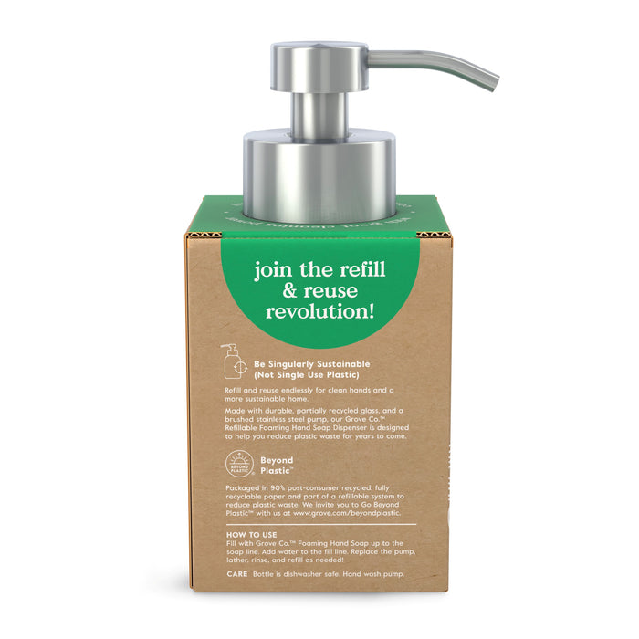 The Grove Co. Reusable Glass Foaming Hand Soap Dispenser features a cardboard package with a metal pump, promoting the message: join the refill & reuse revolution. It highlights eco-friendly materials to fight plastic waste and foster sustainable habits.