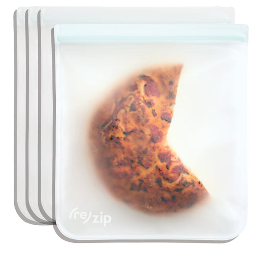 The (re)zip Reusable Leakproof Gallon Bags are translucent, food-safe silicone storage bags featuring the (re)zip logo. Perfect as freezer bags, they’re reusable and hold items like a partially eaten slice of pizza.