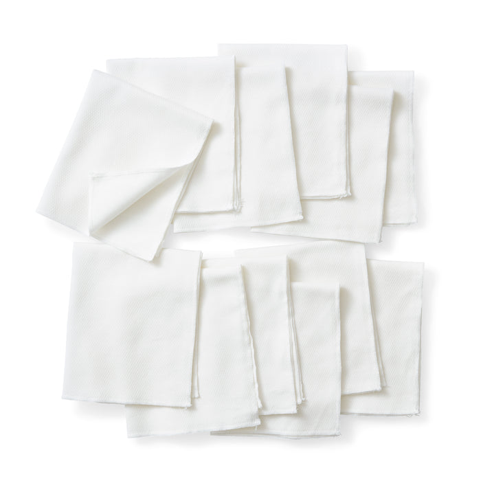 Esembly Babys Reusable Paper Towels, crafted from certified 100% unbleached organic cotton, are neatly arranged—some folded, others layered—against a plain white background.