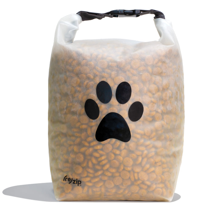 The (re)zip Reusable Pet Food Storage Bag - Large, 40 Cup is a transparent bag with a black paw print and roll-up buckle closure, ideal for storing or traveling with kibble.