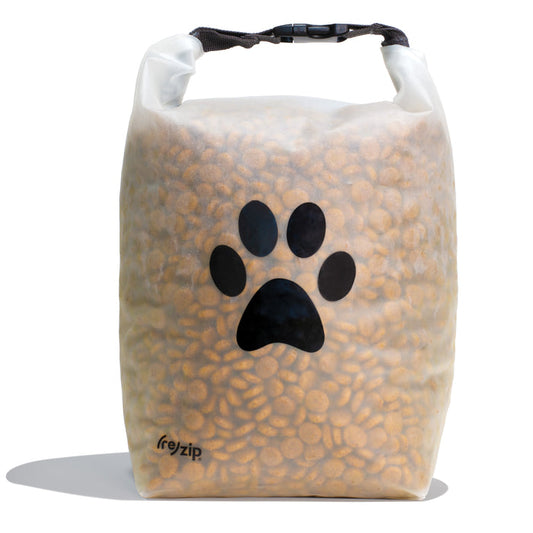 The (re)zip Reusable Pet Food Storage Bag - Large, 40 Cup is a transparent bag with a black paw print and roll-up buckle closure, ideal for storing or traveling with kibble.