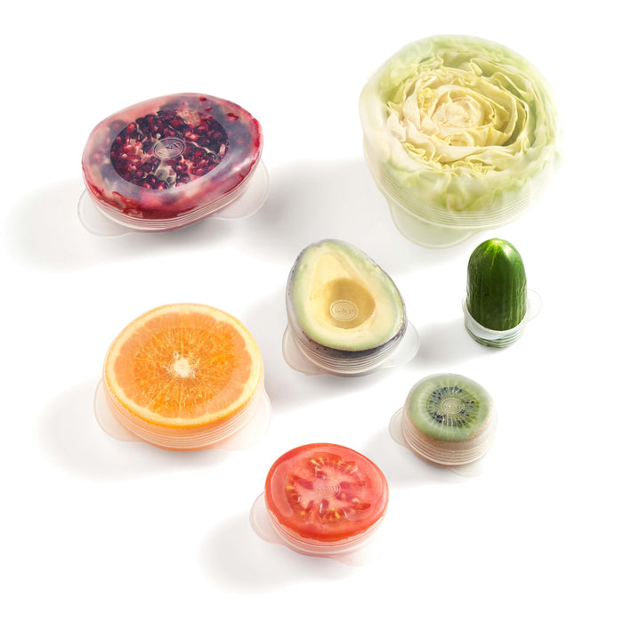W&Ps Reusable Produce Saver Stretch Lids are displayed on a white background. Theyre BPA-free containers designed to preserve fruits and vegetables like pomegranate, cabbage, orange, avocado, cucumber, tomato, and kiwi.