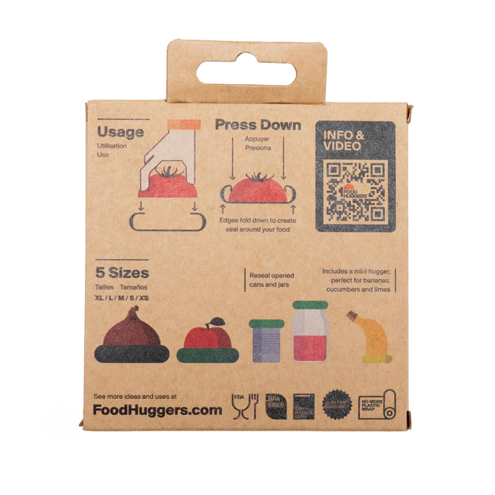The brown cardboard packaging for Food Huggers Reusable Silicone Food Savers includes space-saving storage tips and illustrated sealing instructions. A QR code labeled Info & Video offers further details, with images of the product preserving fresh produce and sealing fruits and jars.