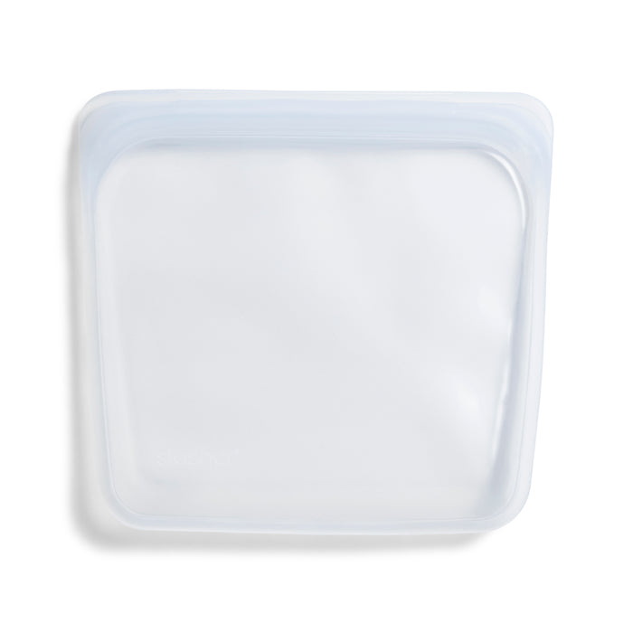 The Stasher Reusable Silicone Sandwich Bag is BPA-free, transparent, and square-shaped with sealed edges, ideal for storing food or other small items.
