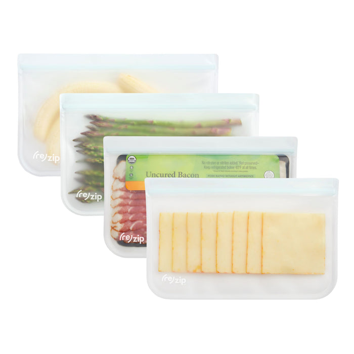 Three (re)zip Reusable Slim Deli & Leftover Bags, shown with banana halves, asparagus spears, uncured bacon, and cheese slices, are BPA-free and transparent with white tops for easy food visibility.