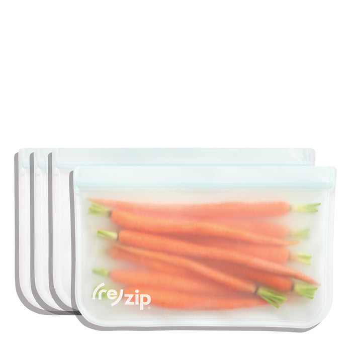 Four (re)zip Reusable Slim Deli & Leftover Bags, made from BPA-free silicone, are displayed. The front bag contains fresh carrots, while the other three freezer-safe bags are empty and stacked neatly behind.