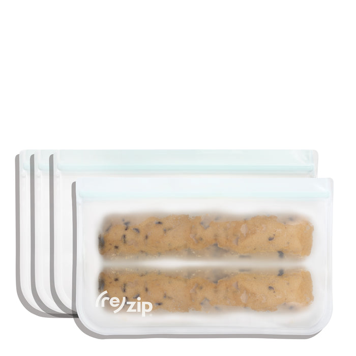 Three (re)zip Reusable Slim Deli & Leftover Bags, translucent and BPA-free with white seals, are stacked. The front bag holds two rolls of cookie dough and features the (re)zip brand name.