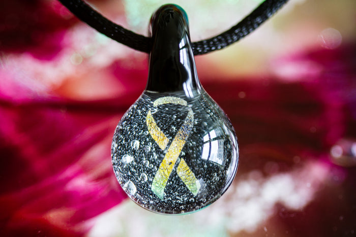 Ribbon hologram pendant infused with cremation ashes suspended from an adjustable cord