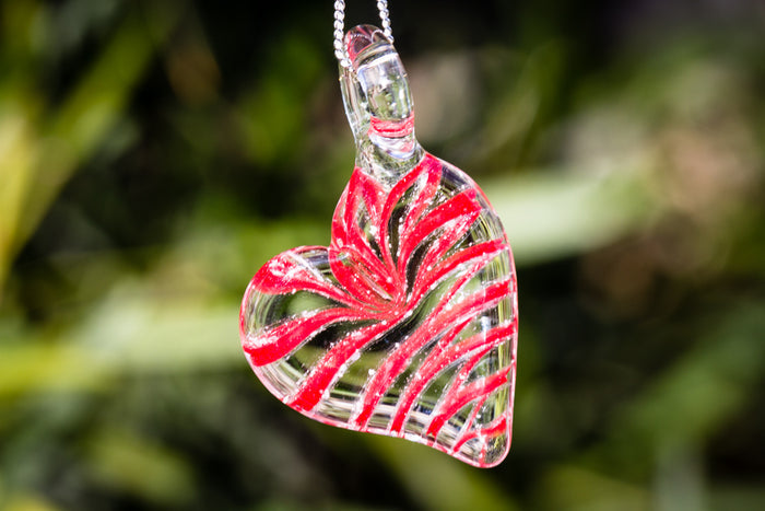 Ripple Heart Necklace pendant infused with cremation ashes in a clear glass heart with red swirls on a silver chain