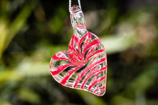 Ripple Heart Necklace pendant infused with cremation ashes in a clear glass heart with red swirls on a silver chain