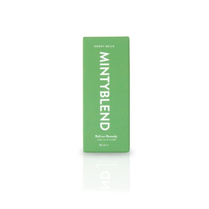 The green rectangular box labeled Minty Blend features Honey Belles Roll-on Remedy, enriched with essential oils. This 10 ml box stands elegantly on a reflective white surface, capturing the soothing essence of aromatherapy.