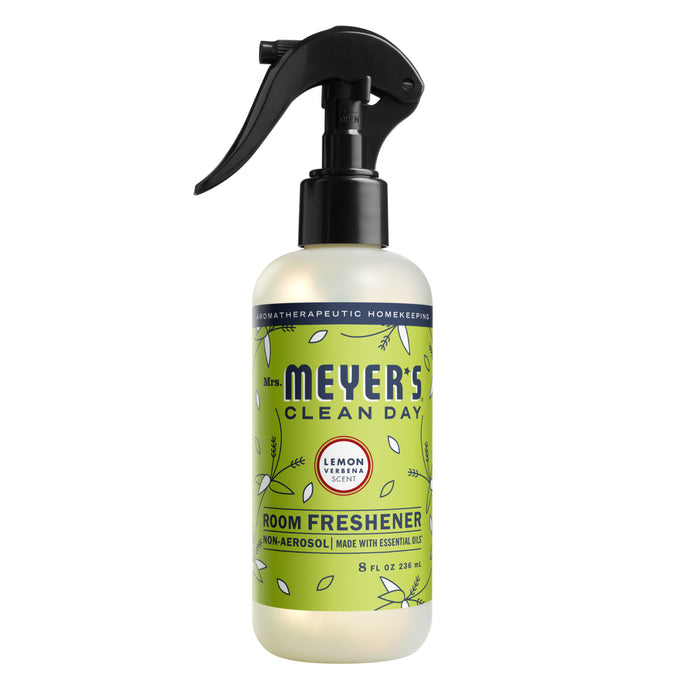 Mrs. Meyers Room Freshener Spray features a lemon verbena scent with leafy graphics and a sleek black nozzle, highlighting its essential oils in a non-aerosol formula for a natural boost.