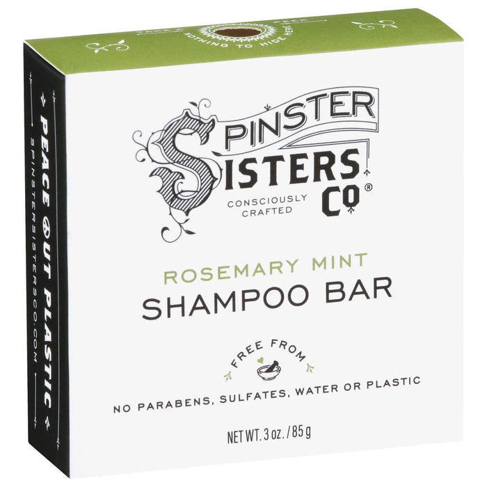 The Rosemary Mint Shampoo Bar by Spinster Sisters Co. comes in green and white packaging, highlighting its essential oils and sulfate-free formula. Free from parabens, water, or plastic, it promotes eco-friendly hair care with the slogan Peace Out Plastic.