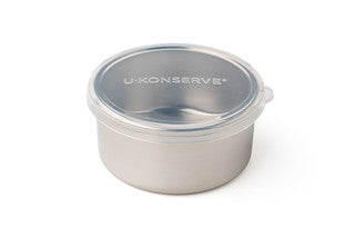The Round Medium Container by U-Konserve features a stainless steel body and a clear plastic lid, displaying the brand in white. This leak-proof, polished container is a sleek, eco-friendly choice.