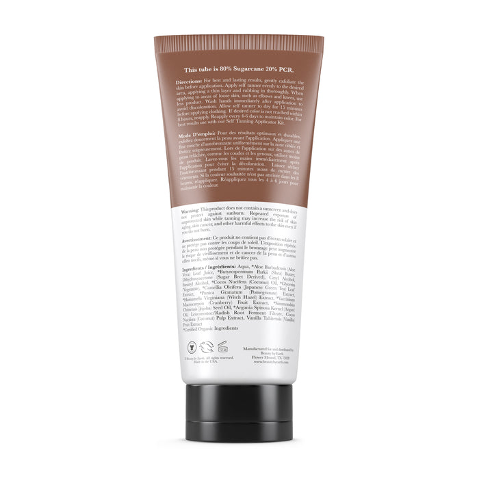 The back of the Beauty by Earth Self Tanner tube, brown and white with a black cap for upright standing, displays text on ingredients, directions, and product info. It promises a golden glow.