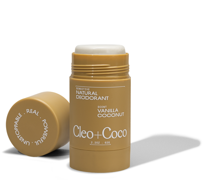 A tube of Cleo & Coco Sensitive Deodorant, Vanilla Coconut scent, with the cap off and beside it. The tan stick with white text holds 2.2 oz (62g) of odor control made from natural ingredients.
