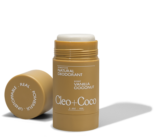 A tube of Cleo & Coco Sensitive Deodorant, Vanilla Coconut scent, with the cap off and beside it. The tan stick with white text holds 2.2 oz (62g) of odor control made from natural ingredients.