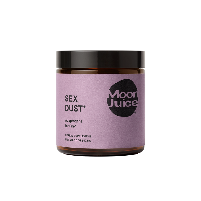 A jar of Moon Juices Sex Dust features a purple label and black lid, containing a 1.5 oz herbal supplement designed for libido support and boasting adaptogens for hormonal balance and creative energy.