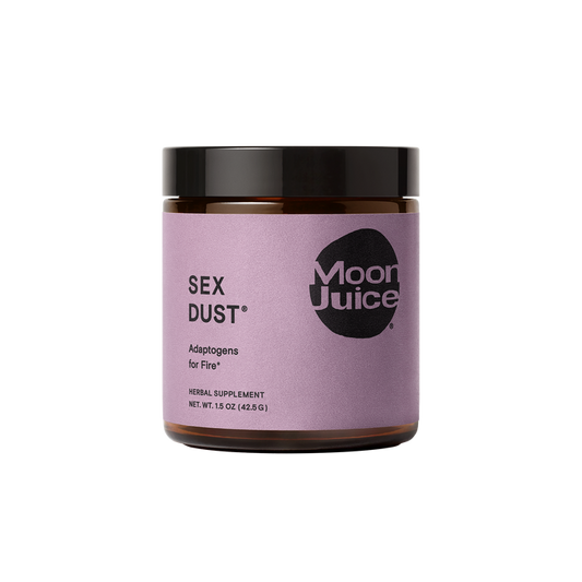 A jar of Moon Juices Sex Dust features a purple label and black lid, containing a 1.5 oz herbal supplement designed for libido support and boasting adaptogens for hormonal balance and creative energy.