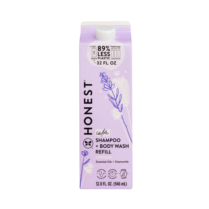 A 32 fl. oz. lavender carton of The Honest Company Shampoo + Body Wash, tear-free and gentle for all ages, featuring illustrations of lavender and chamomile with text on 89% less plastic for sustainability. Infused with calming lavender essential oils and chamomile.