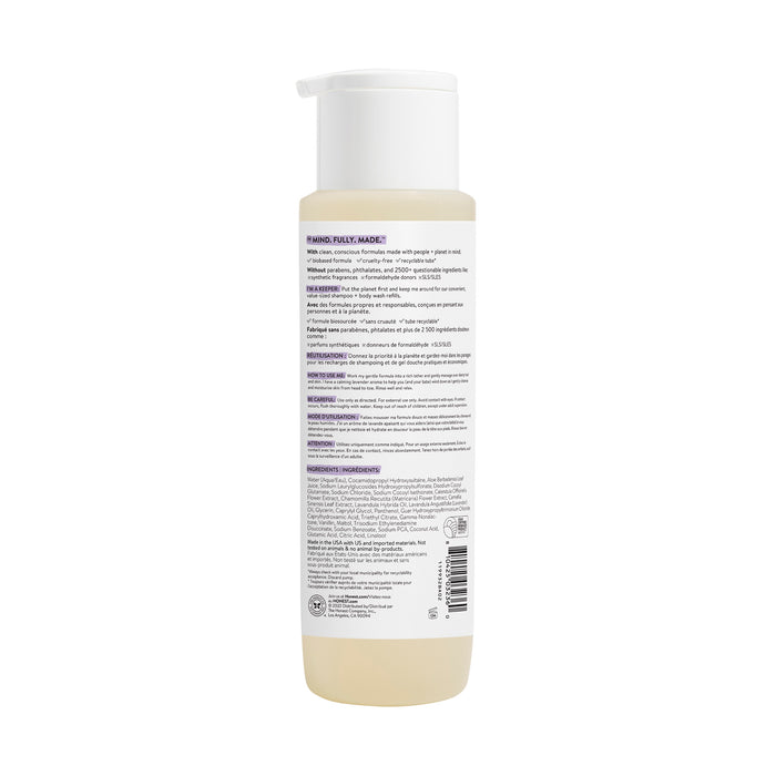 The Honest Companys Shampoo + Body Wash comes in a white cylindrical bottle with a pump dispenser, featuring a label with small multilingual text for instructions and ingredients like soothing Chamomile Extract. Its white cap and base reveal the nourishing liquid inside the translucent bottle.