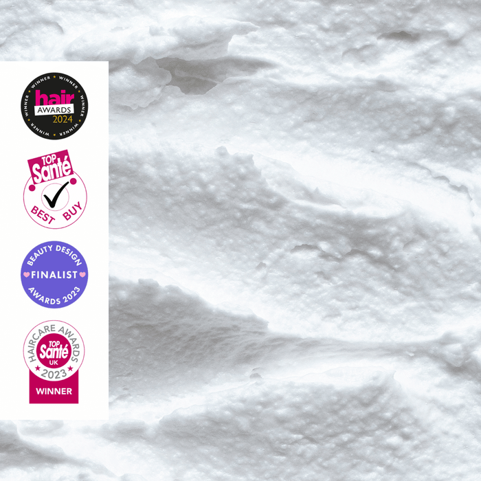 White cream texture with four circular award badges on the left: Hair Awards 2024, Top Santé Best Buy, Beauty Design Awards 2023, and Top Santé UK Care Award Winner 2023.