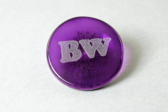 Purple round sharing stone engraved with BW in white
