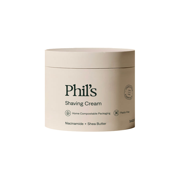 Phil's Shaving Cream comes in a beige, plastic-free, home compostable 3.4 oz container with green text. It features niacinamide and moisturizing shea butter for a luxurious shave.