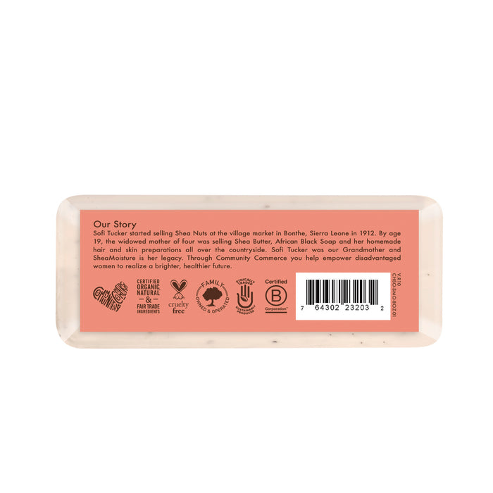 A rectangular SheaMoisture Shea Butter Bar Soap rests on its side, displaying a label with brand story text, certification icons, a barcode, and light brown packaging—crafted especially for brightening dull skin and nourishing melanin-rich skin.