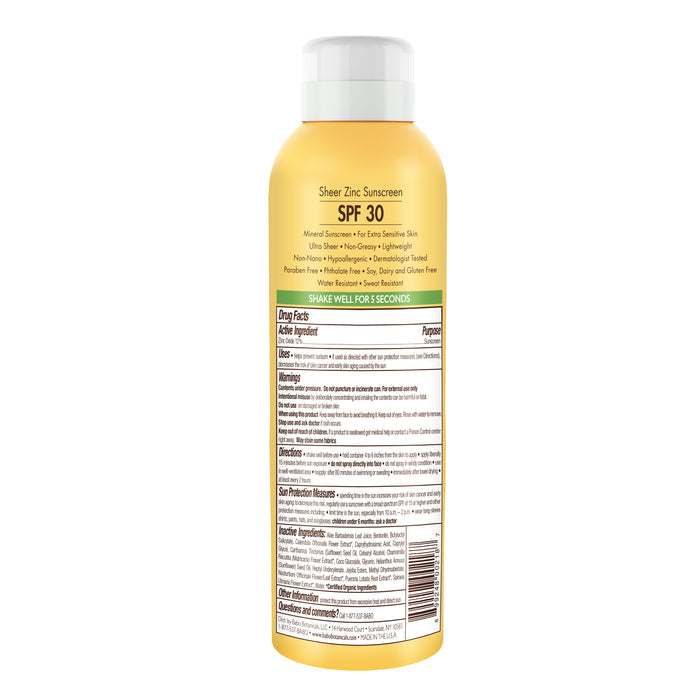 A yellow spray bottle labeled Sheer Zinc Continuous Spray - SPF30 by Babo Botanicals emphasizes its mineral-based formula, making it ideal for sensitive skin, with drug facts and usage instructions on the back.