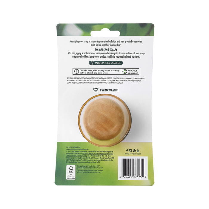 The image displays the back of EcoTools Shower Scalp Massager package, detailing its use for deep cleansing and hair growth, along with cleaning, drying, and replacement instructions. The packaging highlights its eco-friendly and recyclable attributes.