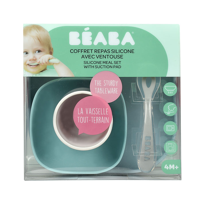 The BEABA Silicone Baby Feeding Set, ideal for infants 4 months and older, includes a teal bowl with a BPA-free suction base and matching spoon. A baby chewing on the spoon is shown at the top left. Packaging features text in both French and English.
