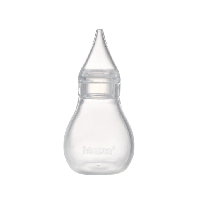 The Haakaa Silicone Baby Nasal Aspirator features a clear, bulb-shaped design with a pointed tip, made from hypoallergenic silicone. It ensures safe and gentle cleaning of baby airways, with haakaa embossed near the base.