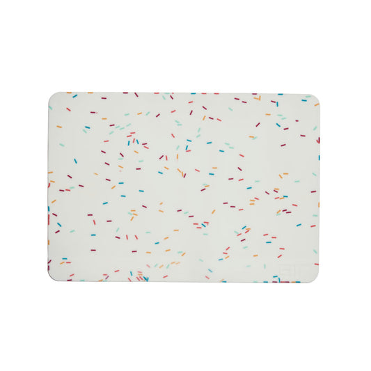 The GIR Silicone Baking Mat features a white background with multicolored, scattered sprinkles in blue, red, orange, and green. This eco-friendly kitchen essential combines style with sustainability for your daily cooking needs.