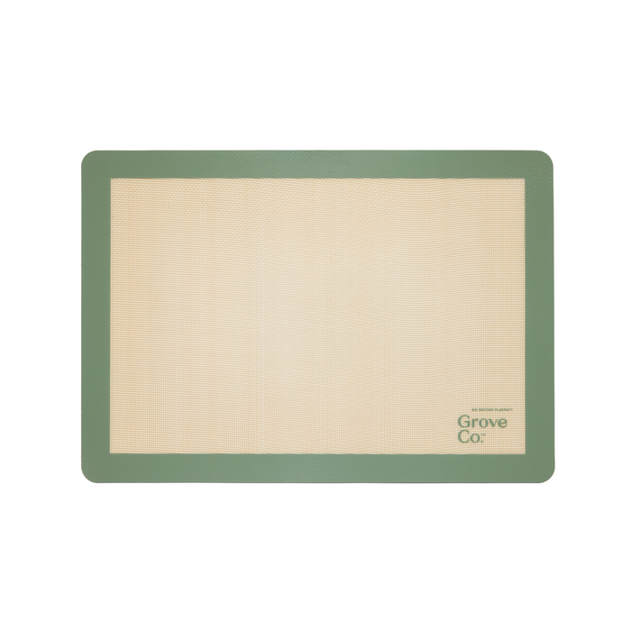 The Silicone Baking Mat from Grove Co. is rectangular and eco-friendly, with a beige center and green border. Grove Co. is elegantly printed on the bottom right, blending style and functionality into your baking routine.