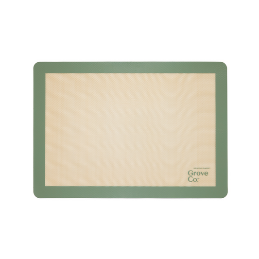 The Silicone Baking Mat from Grove Co. is rectangular and eco-friendly, with a beige center and green border. Grove Co. is elegantly printed on the bottom right, blending style and functionality into your baking routine.