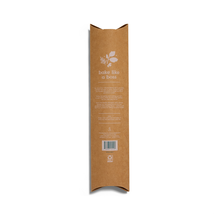 The tall, brown rectangular cardboard packaging for the Silicone Baking Mat by Grove Co. features a white plant design and the text bake like a boss. Eco-friendly symbols, including a barcode and recycling icons, are at the bottom, while pointed flaps are on both top and bottom.