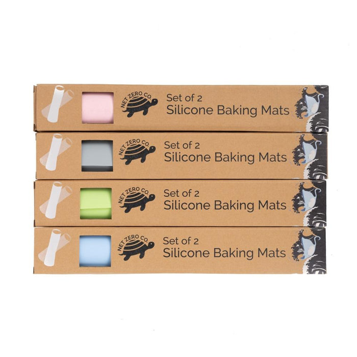 Four boxes of Net Zero Co.s Silicone Baking Mats—Reusable Baking Un-Paper in pastel pink, blue, green, and white feature a Set of 2 Silicone Baking Mats sleeve with a minimalist black cat design. Made from food-grade silicone, they provide an eco-friendly alternative to traditional options.