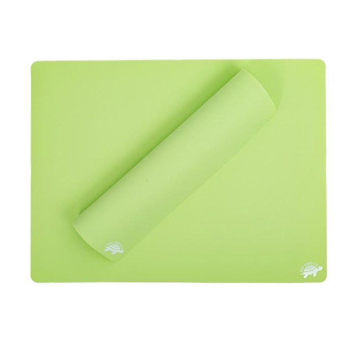 The light green, rectangular Silicone Baking Mats - Reusable Baking Un-Paper by Net Zero Co. are crafted from food grade silicone and eco-friendly materials. Partially rolled on one side with hedgehog logos in corners, they blend style and safety in your kitchen.