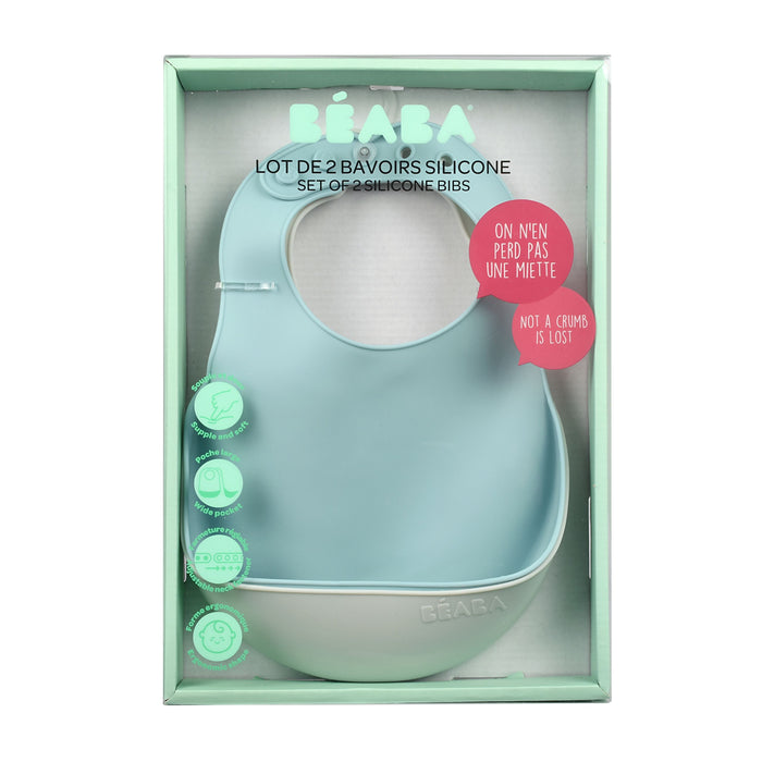 The BEABA Silicone Bibs set includes two bibs in mint and light blue, featuring a crumb-catching pocket. They are easy to clean, comfortable, dishwasher safe, and come with multilingual descriptions. The packaging emphasizes their practicality as baby feeding essentials.