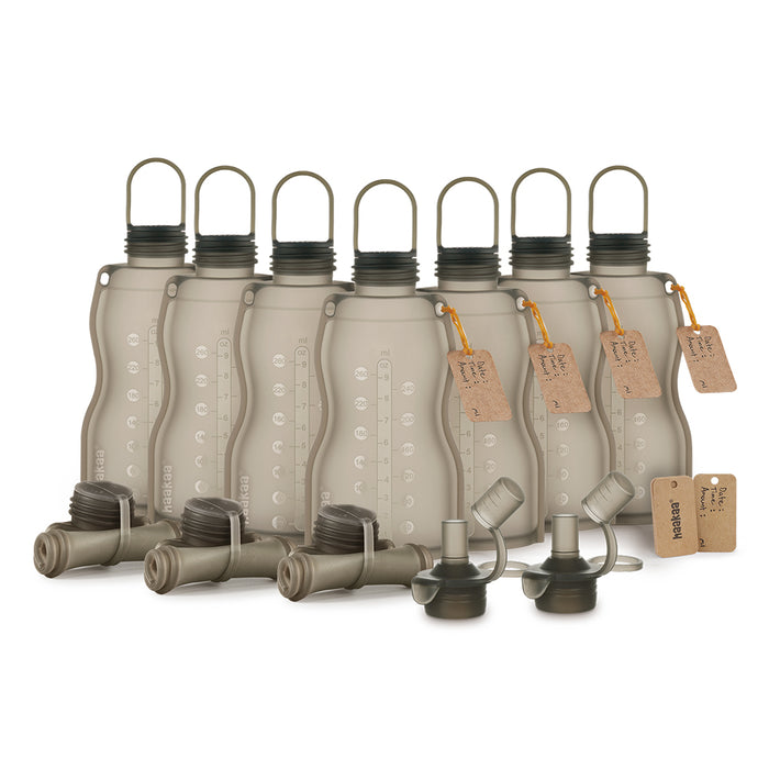 The Haakaa Silicone Milk Storage Bag & Sippy Spout Combo Pack includes six gray hydration bladders with black caps, lay-flat handles, and measurement markings—ideal for eco-conscious parents. It features two spare caps with hoses and two tags, making them baby-feeding essentials.