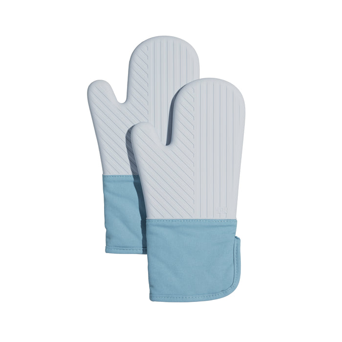 The GIR Silicone Oven Mitts are gray, BPA-free, and feature heat-resistant silicone with vertical grooves and a thumb section. They come with a light blue fabric cuff, overlapping slightly for ease of use.