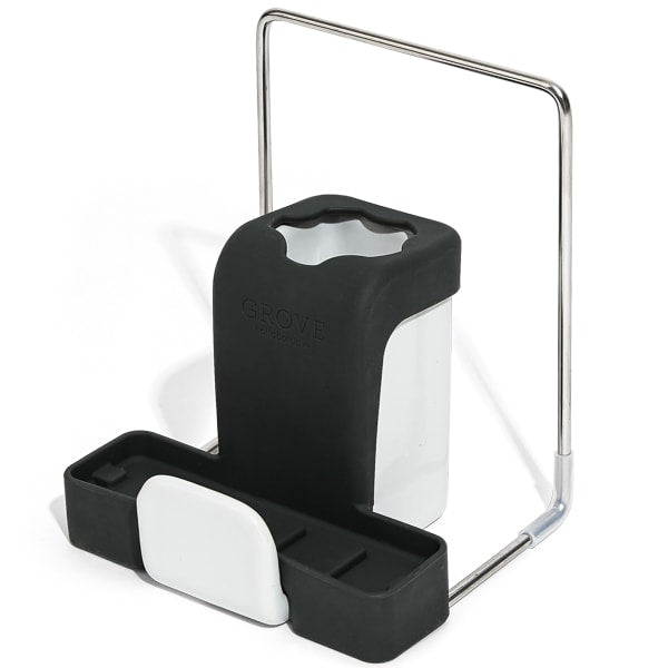 The Grove Co. Sink-Side Caddy is a black and white organizer with compartments for sponges and brushes. Featuring a metal handle, this durable, plastic-free caddy offers a sleek, modern look.