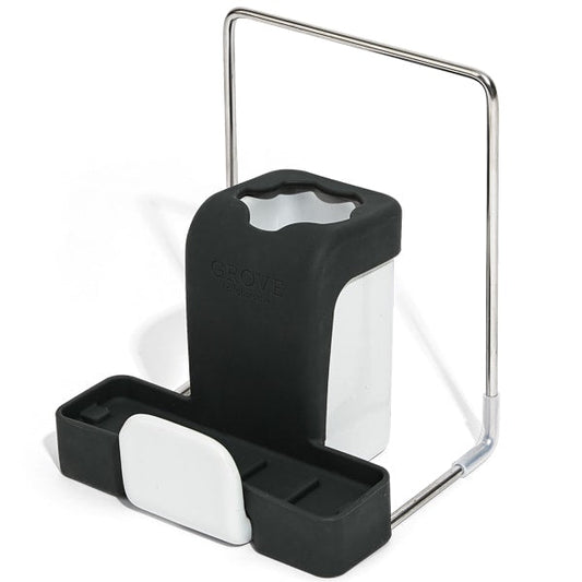 The Grove Co. Sink-Side Caddy is a black and white organizer with compartments for sponges and brushes. Featuring a metal handle, this durable, plastic-free caddy offers a sleek, modern look.
