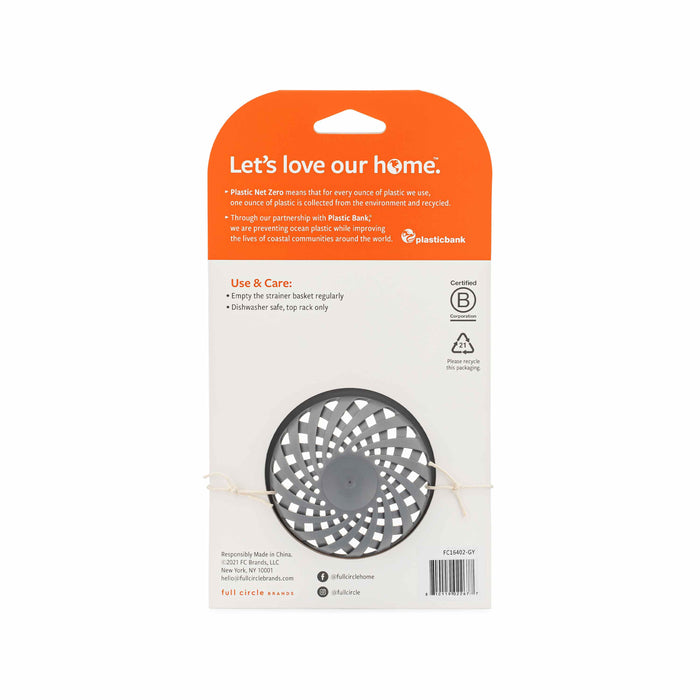The Full Circle Sinksational Sink Strainer comes in white packaging with orange Lets love our home text. The black circular basket is eco-friendly, and the package includes instructions and recycled plastic details.
